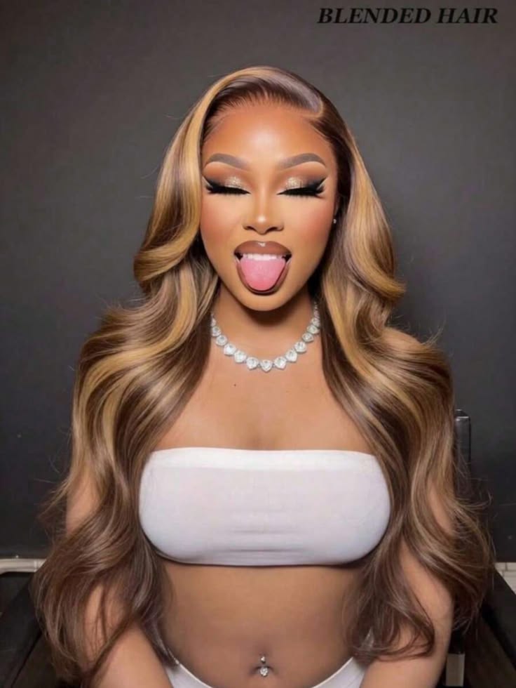 Honey blonde waves with a softly swept part